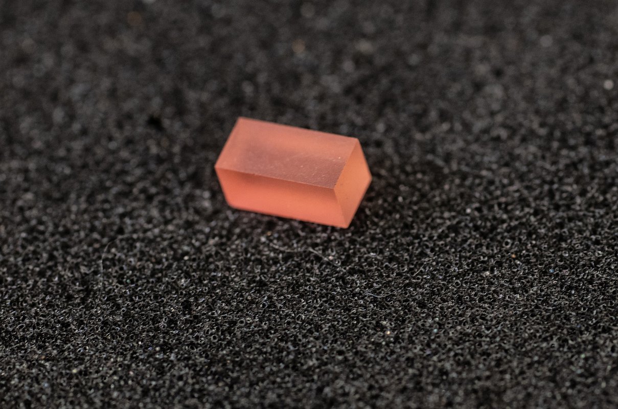 Closeup of the pink crystalline material called lithium holmium yttrium fluoride.